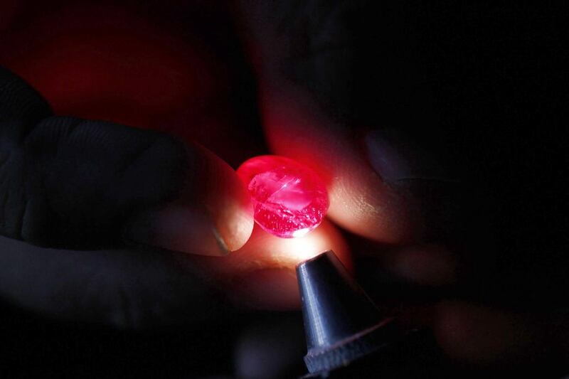 A ruby cutter inspects a ruby in Mogok. Myanmar rubies are preferred for their clarity and quality, particularly those with the 'Pigeon's Blood' hue. Soe Zeya Tun / Reuters