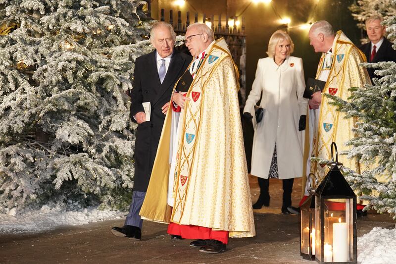 King Charles, Dean Hoyle and Queen Consort Camilla at the carol service. PA
