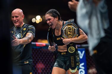 VANCOUVER, CANADA - JUNE 10: Amanda Nunes takes one last celebration with her titles after announcing her retirement during the UFC 289 event at Rogers Arena on June 10, 2023 in Vancouver, Canada.    Jordan Jones / Getty Images / AFP (Photo by Jordan Jones  /  GETTY IMAGES NORTH AMERICA  /  Getty Images via AFP)