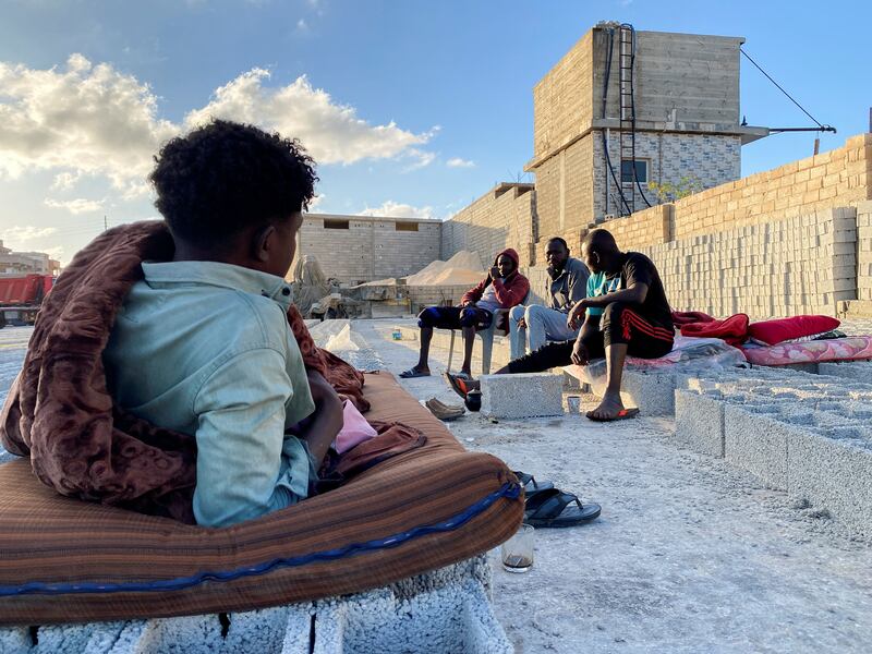 Sudanese workers who lost family members and friends during the disaster sit outside a tile factory in Derna. Reuters