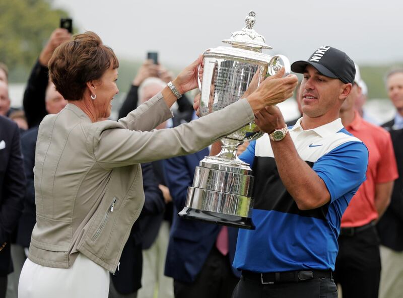 PGA president Suzy Whaley, left, hands Brooks Koepka the Wanamaker Trophy. AP Photo