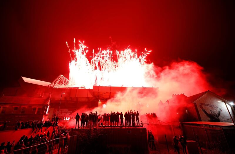 Liverpool fans celebrate outside Anfield. Getty