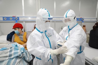 A medical worker writes down a patient's dietary information on a colleague's protective suit inside Leishenshan hospital, a makeshift hospital to treat patients with the novel coronavirus, in Wuhan, Hubei province, China February 16, 2020. Picture taken February 16, 2020. Courtesy: China Daily 