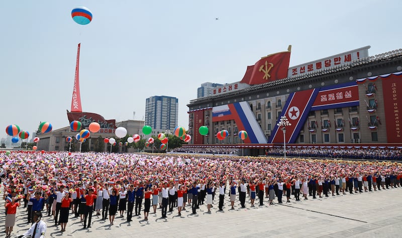 North Koreans at a welcoming ceremony for Mr Putin in Pyongyang. EPA / Sputnik