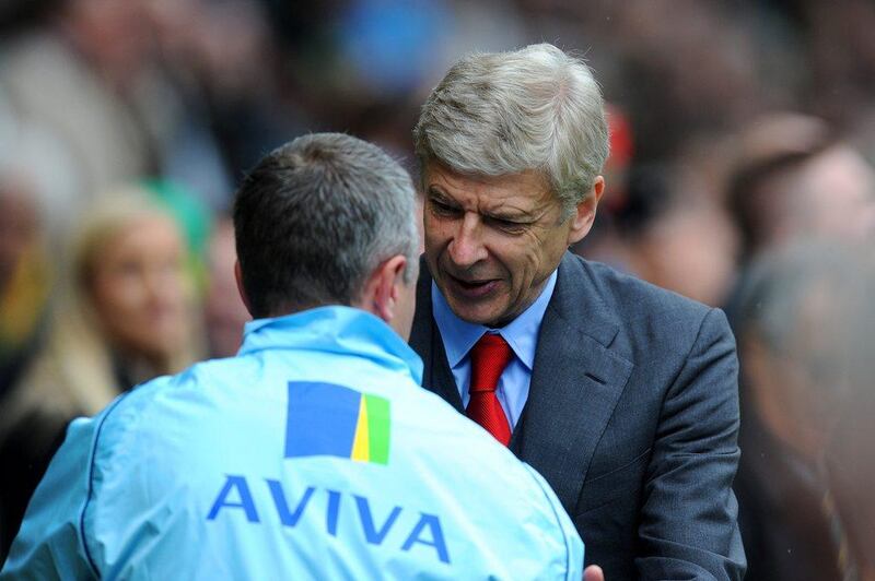 Arsenal manager Arsene Wenger greets Norwich City manager Neil Adams before their Premier League season-ending match on Sunday. Steve Bardens / Getty Images / May 11, 2014