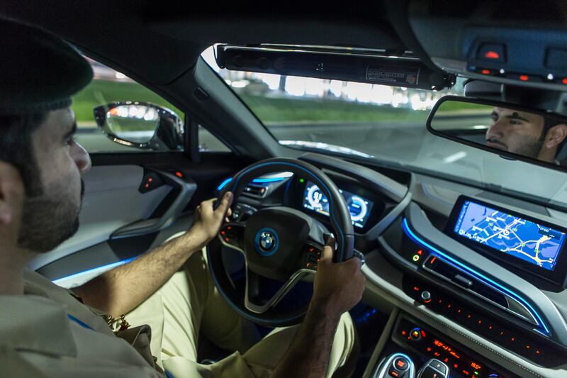 DUBAI, UNITED ARAB EMIRATES, 16 JULY 2015. The Dubai Police super luxury cars. A quick drive with Dubai Police in their BMW I8, Porche Panamera and Mercedes GWagon Brabus that ended in a photo opertunity at the Dubai Mall Fountain where members of the public had a chance to see the cars and interact with the police. Lieutenant Obaid Matar Bin Abed Almuhairi from the Tourist Police Department, Tourist Police Patrols Section. (Photo: Antonie Robertson/The National) Journalist: Dana Moukhallati. Section: National. *** Local Caption ***  AR_1607_Police_Luxury_Cars-06.JPG