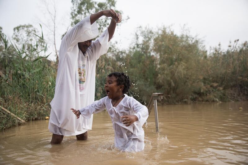 Pilgrims from Ethiopia dip at the Qasr Al Yahud baptism site in the Jordan River, West Bank. EPA