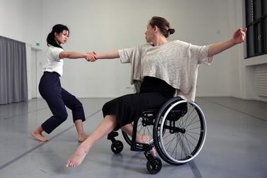 A dancer from the Paris Opera dances with a disabled dancer in her wheelchair during a rehearsal of the ballet "Passage" in Paris, on February 19, 2022.  (Photo by Thomas COEX  /  AFP)