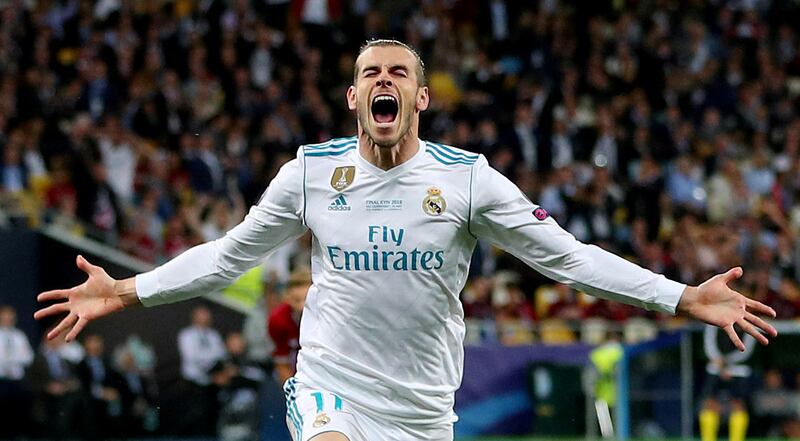 FILE PHOTO: ON THIS DAY -- May 26  May 26, 2018     SOCCER - Real Madrid's Gareth Bale celebrates scoring their second goal in a 3-1 Champions League final win over Liverpool. Bale's brace and errors by Liverpool keeper Loris Karius gave the Spanish side a third straight title in the competition.     Bale came on just past the hour with the score at 1-1 and after three minutes produced a bicycle kick finish and netted again with a speculative long-range effort that somehow went through the hands of the unfortunate Karius.     The German keeper had earlier handed Real a 51st minute lead when he threw the ball straight at striker Karim Benzema and the ball rolled into the unguarded net off the Frenchman's leg.  REUTERS/Hannah McKay/File photo