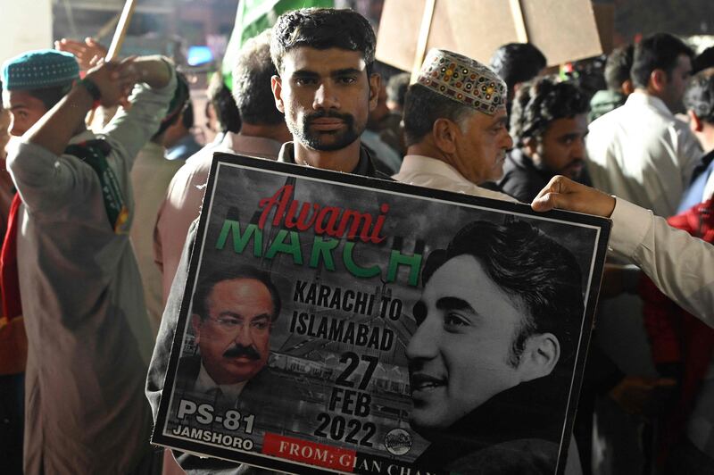 A supporter of the opposition Pakistan Peoples Party holds up a placard as people gather around a truck carrying PPP chairman Bilawal Bhutto Zardari, in Pakistan's capital Islamabad. AFP