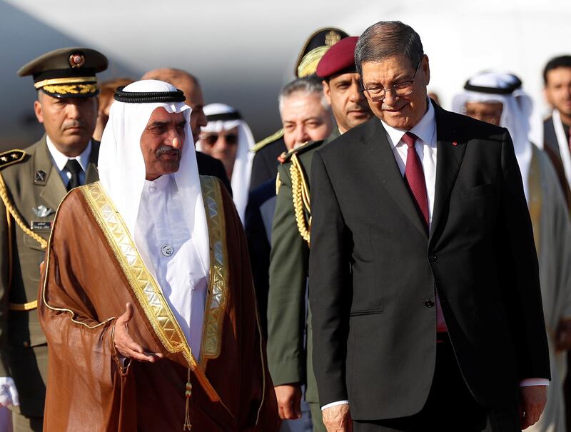 Ruler of Fujairah, Sheikh Hamad Bin Mohammed Al Sharqi, left, walks next to Tunisian Presidential Advisor for political affairs, Habib Essid, upon his arrival at Tunis-Carthage international airport to attend the Arab Summit, in Tunis, Tunisia. Reuters