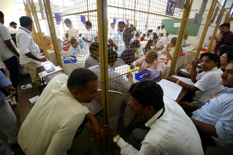 Indian election officials tally votes from electronic voting machines at counting centre in Bengaluru.  EPA