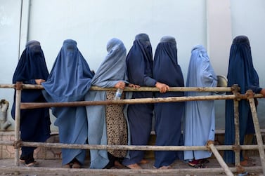 In this photo taken on June 12, 2018, Afghan burqa-clad women stands as they wait to receive food donated by a private charity during the Islamic holy month of Ramadan, in Mazar-i-Sharif. Muslims throughout the world are marking the month of Ramadan, the holiest month in the Islamic calendar during which devotees fast from dawn till dus. / AFP / FARSHAD USYAN