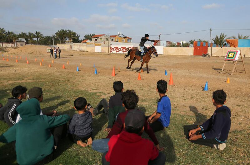 A young Palestinian rider shoots an arrow at a target during a horseback archery training session in Zawayda in the central Gaza Strip. Reuters