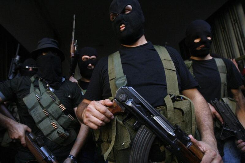 Lebanese masked gunmen from the al-Muqdad clan ready to speak to the press in Beirut's southern suburbs. The Muqdads, a large Lebanese Shiite Muslim clan, says it has kidnapped at least 20 Syrians to try to secure the release of a family member abducted near Damascus this week. AFP PHOTO