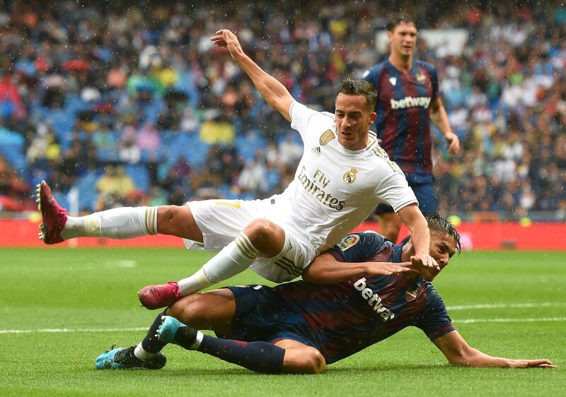 Lucas Vazquez of Real Madrid is tackled by Oscar Duarte of Levante. Getty Images
