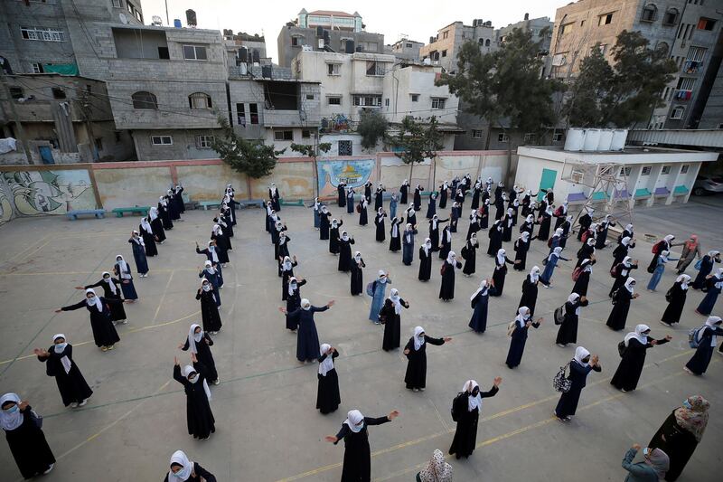 Palestinian students take part in the morning assembly at Beach refugee camp in Gaza City after schools partially reopened amid the coronavirus disease outbreak. Reuters