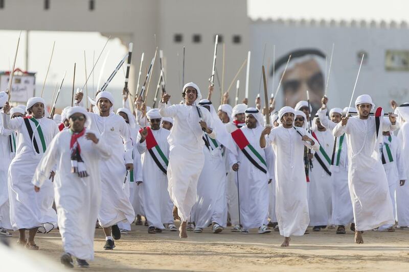 Audience members cheer tribesmen participating in the Union March during the Sheikh Zayed Heritage Festival 2015. Philip Cheung / Crown Prince Court - Abu Dhabi