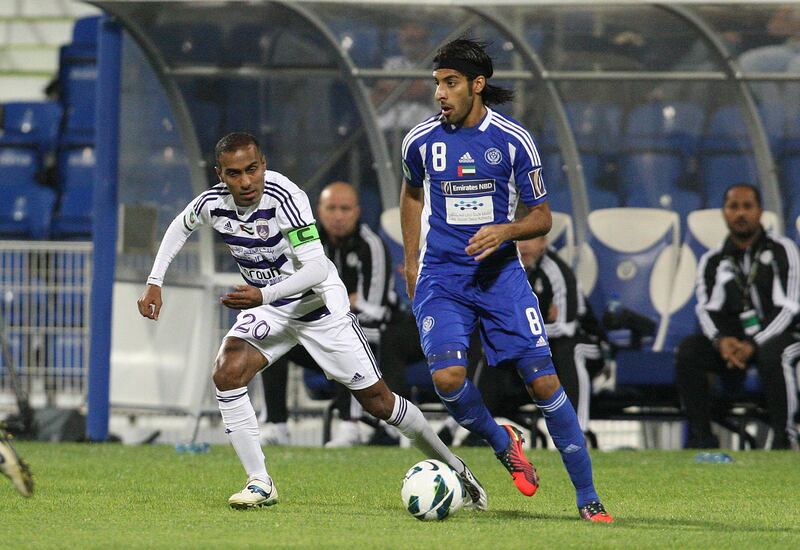 Dubai, United Arab Emirates, Dec 16 2012, Al-Maktoum Stadium Dubai, Al nasr v Al Ain-  (back left) Al Ains #Helal Saeed and  (right) Al Nasr's # 18 forward Jamal Ibrahim Hussain at midfield during action at Al-Maktoum Stadium in Dubai. Mike Young / The National?