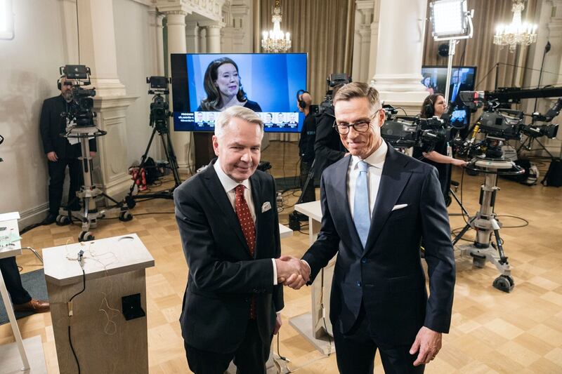 Mr Haavisto and Mr Stubb shake hands at Helsinki City Hall during the election. Bloomberg