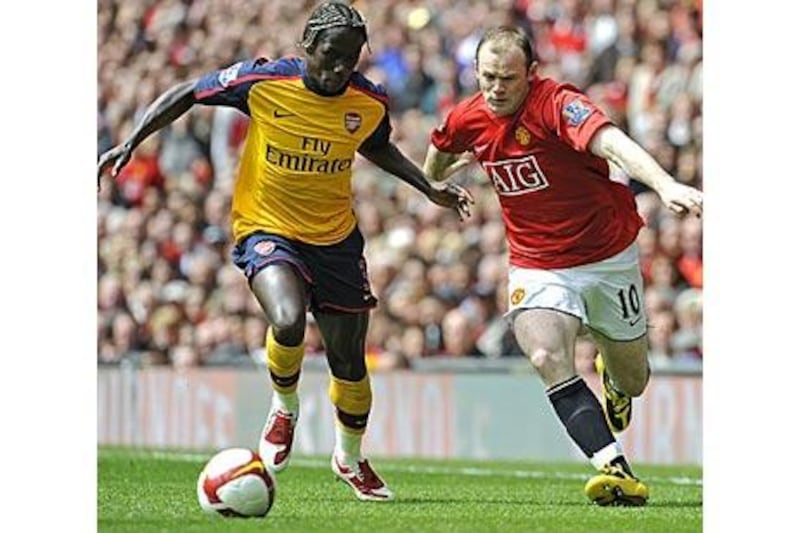 United's Wayne Rooney, right, and Arsenal's Bacary Sagna battle at Old Trafford last season.