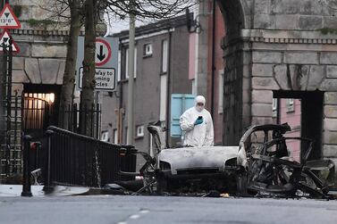 A forensic officer inspects the remains of the van used as a car bomb on an attack outside Derry Courthouse. Getty