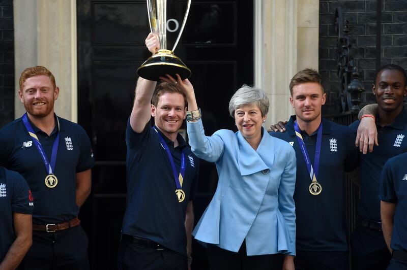 England captain Eoin Morgan and British prime minister Theresa May pose with the World Cup trophy at Downing Street. Getty Images