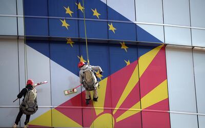 epa07930263 (FILE) - Workers clean the windows of the offices of the European Union decorations  with EU and Macedonian flags in Skopje, North Macedonia, 26 February 2019 (reissued 18 October 2019). EU leaders have delayed the decision for accession talks with North Macedonia and Albania for the third time as they gathered in Brussels for a two-day summit dominated by Brexit talks.  EPA/NAKE BATEV