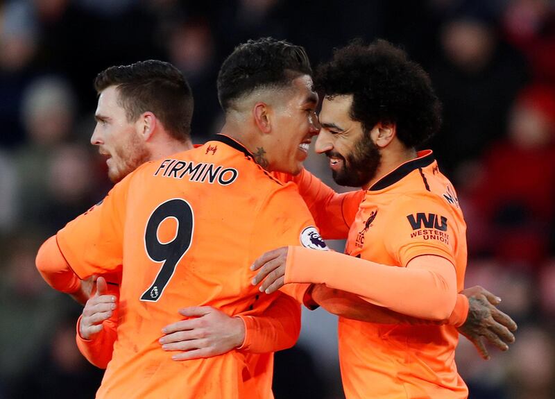 Soccer Football - Premier League - Southampton vs Liverpool - St Mary's Stadium, Southampton, Britain - February 11, 2018   Liverpool's Mohamed Salah celebrates scoring their second goal with Roberto Firmino and Andrew Robertson    REUTERS/Eddie Keogh    EDITORIAL USE ONLY. No use with unauthorized audio, video, data, fixture lists, club/league logos or "live" services. Online in-match use limited to 75 images, no video emulation. No use in betting, games or single club/league/player publications.  Please contact your account representative for further details.