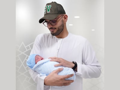 Sultan Alshamsi holds baby Umair, born at 12.01am on Wednesday. Photo: Burjeel Hospital
