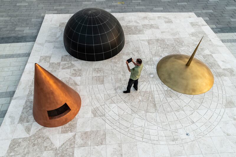 'A point in time' by Khalil Rabah enlarged 11th-century implements used for determining location. Look closely: a small black circule below the gold-coloured spindle shows Dubai on the map the objects create. Photo: Thorsten Arendt