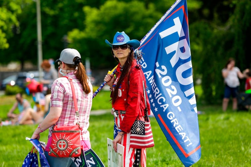 A Trump supporter protests Governor Jay Inslee's stay-at-home order outside the State Capitol in Olympia, Washington on May 9, 2020. The Washington State Patrol estimates about 1,500 people rallied against Governor Jay Inslee’s stay-at-home order. / AFP / Jason Redmond
