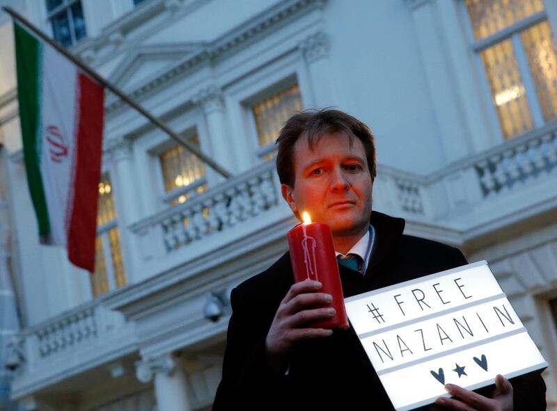 FILE - In this file photo dated Monday, Jan. 16, 2017, Richard Ratcliffe husband of imprisoned charity worker Nazanin Zaghari-Ratcliffe, poses for the media during an Amnesty International led vigil outside the Iranian Embassy in London.  Richard Ratcliffe said Tuesday May 15, 2018, that his wife may face new charges. (AP Photo/Alastair Grant, FILE)