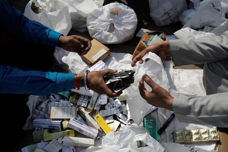 People segregate expired medicines outside a chemist store in New Delhi, India February 2, 2018. REUTERS/Saumya Khandelwal