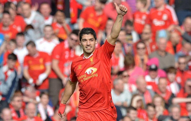 Liverpool FC striker Luis Suarez celebrates scoring his team's second goal on Sunday. Paul Ellis / AFP / March 30, 2014