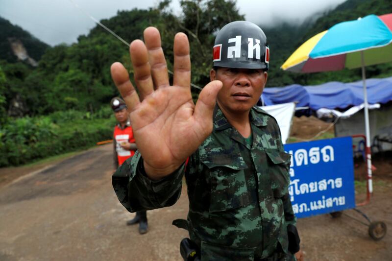 A soldier blocks a road leading to Tham Luang cave complex. Reuters