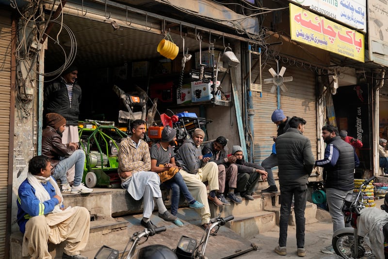 Shopkeepers wait for the power cut to end, in Lahore, northern Pakistan. The blackout lasted several hours. AP Photo