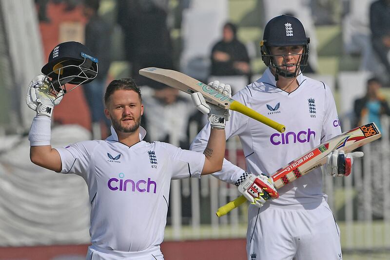 England's Ben Duckett (L) celebrates after scoring a century (100 runs) next to his teammate Zak Crawley (R) during the first day of the first cricket Test match between Pakistan and England at the Rawalpindi Cricket Stadium, in Rawalpindi on December 1, 2022.  (Photo by Aamir QURESHI  /  AFP)