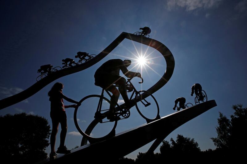 A girl plays in a sculpture in commemoration of the Tour de France in the Pyrenees mountains, near Tarbes. Reuters