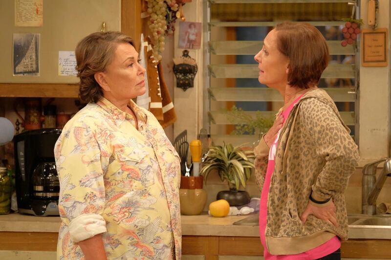 In this image released by ABC, Roseanne Barr, left, and Laurie Metcalf appear in a scene from the reboot of the popular comedy series "Roseanne." ABC, which canceled its "Roseanne" revival over its star's racist tweet, said Thursday, June 21, 2018, it will air a Conner family sitcom minus Roseanne Barr this fall. (Adam Rose/ABC via AP)