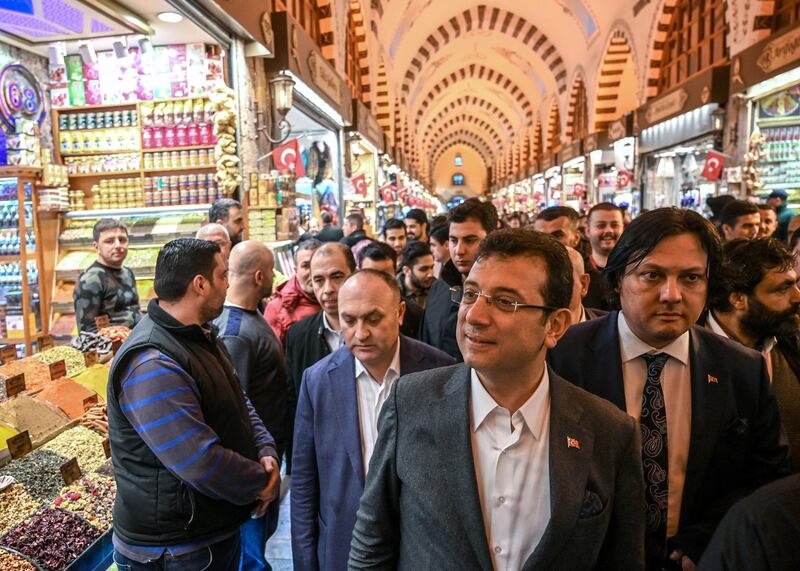 Turkey's main opposition Republican People's Party (CHP) mayoral candidate for Istanbul Ekrem Imamoglu, centre, visits the spice bazaar of Istanbul during his political campaign.  AFP
