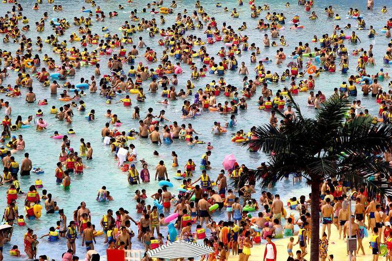 Huge crowds of people play at THEBES Happiness Water World during a continuous high temperature on July 5, 2014 in Shaanxi, Xi’an province of China. ChinaFotoPress / ChinaFotoPress via Getty Images
