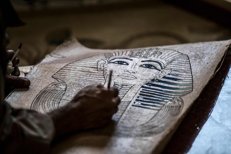 Farmer and painter Said Tarakhan, 60, draws on papyrus sheets in the village of Al Qaramus in Egypt's Sharqiyah province. Farmers in the small village have kept alive the ancient Pharaonic tradition of making papyrus paper.