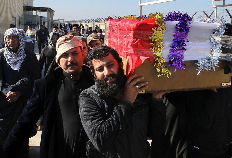 Mourners carry a coffin of prominent social activist Wissam al-Ghrawi in Basra, Iraq, Sunday, Nov. 18, 2018. Iraqi police say religious cleric Wissam, who was linked to the ongoing protests over poor services in Basra, was killed outside his home after suggested that demonstrators should take up arms over the conditions in the city. (AP Photo/Nabil al-Jurani)