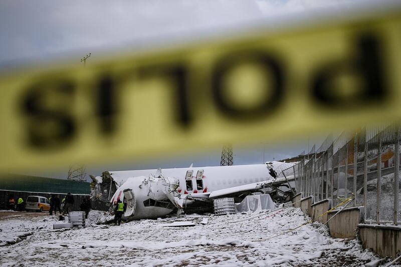 Investigators work at the wreckage of a plane operated by Pegasus Airlines after it skidded Wednesday off the runway at Istanbul's Sabiha Gokcen Airport, in Istanbul. AP Photo