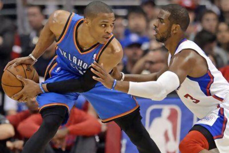 Chris Paul of the Los Angeles Clippers, right, defends against Oklahoma City Thunder's Russell Westbrook in the first half during their game on Sunday. The Thunder won to complete their three-game season sweep of the Clippers. Michael Nelson / EPA