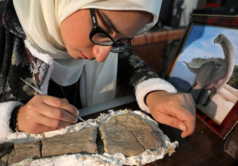 Palaeontologist Sanaa Al Sayed works on a dinosaur fossil discovered in the town of El Mansoura, north of Cairo. Reuters