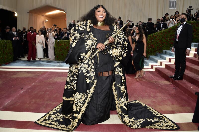 Lizzo, wearing black and gold Thom Browne. AP Photo