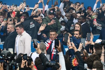 Kylian Mbappe waves to supporters outside the Parc des Princes. AFP