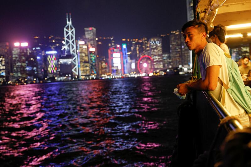 Craftsman Jesse Yu, 32, crosses on a ferry to Victoria Harbour, with the financial district seen in the background, in Hong Kong, China. Newcomers are rejuvenating Peng Chau, reversing an exodus in the 1970s. Reuters